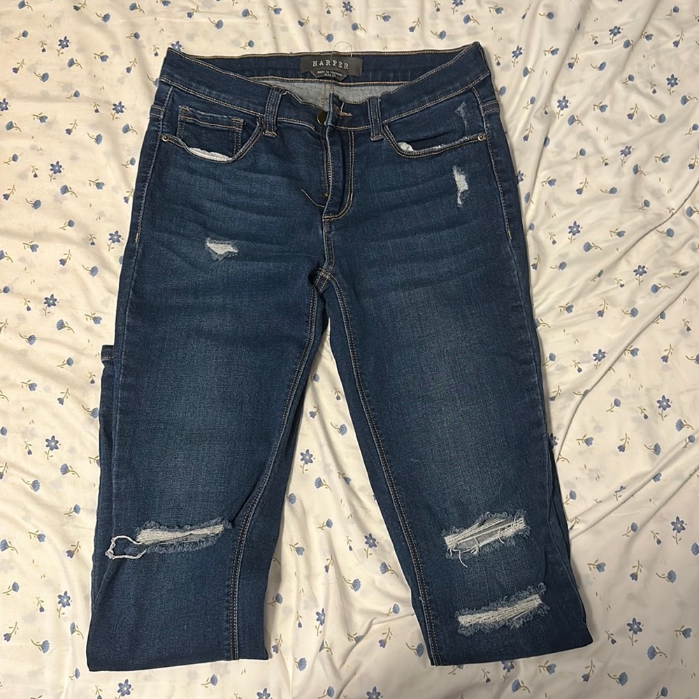 High rise lightly distressed skinny jeans. Dark wash.